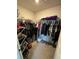 Walk-in closet with shelves and hanging space providing ample storage for clothing and accessories at 737 Daphne Dr, Polk City, FL 33868