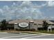 Community entrance to Auburn Cove showcases stacked stone accents and manicured landscaping at 737 Daphne Dr, Polk City, FL 33868