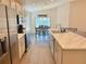 Spacious kitchen with stainless steel appliances, marble countertops, and an adjacent dining area for seamless living at 737 Daphne Dr, Polk City, FL 33868