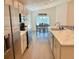 Bright kitchen features stainless steel appliances, modern cabinetry, stone countertops, and eat in dining area at 737 Daphne Dr, Polk City, FL 33868