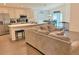 Open-concept living space featuring a kitchen island and comfortable seating with laminate flooring at 737 Daphne Dr, Polk City, FL 33868