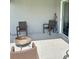 View of outdoor patio area with stylish woven chairs and neutral color palette at 737 Daphne Dr, Polk City, FL 33868