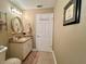 Neutral bathroom with granite countertop, oval mirror, and vanity with storage at 741 Canberra Rd, Winter Haven, FL 33884