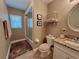 Bathroom featuring a shower-tub combo, floating shelving, and neutral color palette at 741 Canberra Rd, Winter Haven, FL 33884