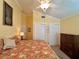Bedroom with twin closets, ceiling fan, and tropical bedspread at 741 Canberra Rd, Winter Haven, FL 33884