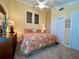 Bedroom featuring a ceiling fan, tropical bedspread, and neutral walls at 741 Canberra Rd, Winter Haven, FL 33884