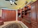 Bedroom featuring custom cabinets, built-in shelves, and yellow colored walls at 741 Canberra Rd, Winter Haven, FL 33884