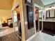 Hallway with mirrored closet doors leads to a main bedroom and bathroom at 741 Canberra Rd, Winter Haven, FL 33884