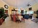 Bright dining room with formal table, fireplace, and open layout to the kitchen and living area at 741 Canberra Rd, Winter Haven, FL 33884