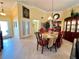 Open dining room with a chandelier, stylish furnishings, and easy access to the kitchen at 741 Canberra Rd, Winter Haven, FL 33884
