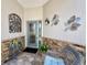 Inviting covered entryway with decorative accents and stone flooring at 741 Canberra Rd, Winter Haven, FL 33884