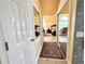 Hallway with mirrored closet doors leads to a main bedroom featuring natural light at 741 Canberra Rd, Winter Haven, FL 33884