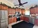 Kitchen showcases wooden cabinets, stainless steel appliances, and granite countertops at 741 Canberra Rd, Winter Haven, FL 33884