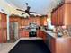 Well-lit kitchen featuring wooden cabinets, stainless steel appliances, and decorative backsplash at 741 Canberra Rd, Winter Haven, FL 33884