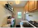Laundry area featuring a utility sink, modern washing machine, and overhead storage at 741 Canberra Rd, Winter Haven, FL 33884