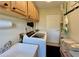 Neutral laundry area featuring a utility sink and a modern washing machine at 741 Canberra Rd, Winter Haven, FL 33884
