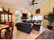 Comfortable living room featuring a stone fireplace, arched windows, and seamless access to the outdoor space at 741 Canberra Rd, Winter Haven, FL 33884