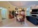 Bright living room with dining area, fireplace, and views into the kitchen at 741 Canberra Rd, Winter Haven, FL 33884