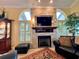 Relaxing living room featuring a stone fireplace, comfortable seating, and ample natural light at 741 Canberra Rd, Winter Haven, FL 33884