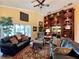 Inviting living room featuring a bar, comfortable seating, and natural lighting at 741 Canberra Rd, Winter Haven, FL 33884
