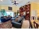 Inviting living room showcasing custom built-ins with bar area and comfortable seating arrangement at 741 Canberra Rd, Winter Haven, FL 33884