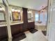 Main bathroom featuring a dual sink vanity, tub and a walk in shower at 741 Canberra Rd, Winter Haven, FL 33884