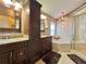 Beautiful main bathroom features dual sinks, granite countertops, walk in shower, and a soaking tub at 741 Canberra Rd, Winter Haven, FL 33884