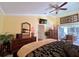 Comfortable main bedroom boasts a ceiling fan, a decorative wall art, and outdoor access at 741 Canberra Rd, Winter Haven, FL 33884