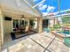 Outdoor patio area featuring brick flooring, a dining set and a stone water feature at 741 Canberra Rd, Winter Haven, FL 33884