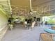 Spacious outdoor patio area featuring ample seating and ceiling fans for comfortable dining at 741 Canberra Rd, Winter Haven, FL 33884
