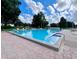 Large outdoor community pool with plenty of lounge chairs and a clear blue sky overhead at 741 Canberra Rd, Winter Haven, FL 33884