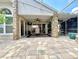 A covered patio overlooks a tiled outdoor space that includes a screened-in patio with water feature at 741 Canberra Rd, Winter Haven, FL 33884