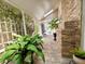 The sunroom features brick accents, potted plants and offers a view of the patio and pool area at 741 Canberra Rd, Winter Haven, FL 33884