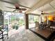 A screened in patio with ceiling fans, brick accents and a view of the pool area with a water feature at 741 Canberra Rd, Winter Haven, FL 33884