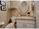Powder room featuring a granite vanity and floating shelves at 741 Canberra Rd, Winter Haven, FL 33884