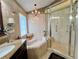Shower with glass door showcasing tile surround and updated fixtures at 741 Canberra Rd, Winter Haven, FL 33884