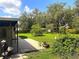 Serene backyard featuring lush greenery and a peaceful patio area, ideal for relaxation and outdoor dining at 8110 Walt Williams Rd, Lakeland, FL 33809