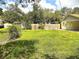 Expansive backyard with a mix of grassy areas and mature trees, offering privacy and space for recreation at 8110 Walt Williams Rd, Lakeland, FL 33809