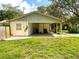 Spacious attached carport offering covered parking and additional storage space on a large grassy lot at 8110 Walt Williams Rd, Lakeland, FL 33809