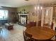 Open-concept dining and living area with tile floors and a traditional fireplace adding warmth and character at 8110 Walt Williams Rd, Lakeland, FL 33809