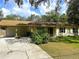 Charming single-story home with a well-maintained front yard and a covered carport, offering curb appeal at 8110 Walt Williams Rd, Lakeland, FL 33809