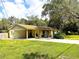 Lovely home featuring a covered carport and a spacious front yard, perfect for outdoor activities at 8110 Walt Williams Rd, Lakeland, FL 33809