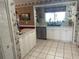 Spacious kitchen featuring white cabinets, stainless steel appliances, and a large window for ample natural light at 8110 Walt Williams Rd, Lakeland, FL 33809