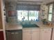 Functional kitchen with white cabinets and a dual-basin sink, offering ample storage and workspace at 8110 Walt Williams Rd, Lakeland, FL 33809