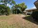 Expansive backyard with patio furniture and large trees offers serene outdoor living at 816 Casselberry Dr, Lake Wales, FL 33853