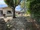 Spacious backyard features a grill, patio furniture, and mature trees at 816 Casselberry Dr, Lake Wales, FL 33853