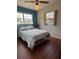 Bedroom with hardwood floors, two windows and a ceiling fan at 816 Casselberry Dr, Lake Wales, FL 33853