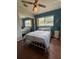 Bedroom featuring a closet with mirrored doors, new hardwood floors, a ceiling fan and natural light at 816 Casselberry Dr, Lake Wales, FL 33853
