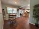 Dining room area features a wooden dining table, light-blue walls and new hardwood floors at 816 Casselberry Dr, Lake Wales, FL 33853