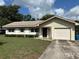 Charming single-Gathering home with a well-maintained lawn, shutters, and attached one car garage at 816 Casselberry Dr, Lake Wales, FL 33853